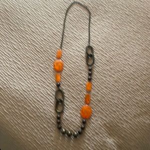 Long necklace with orange and bronze coloring.